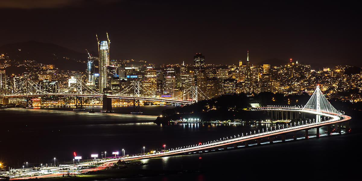 Photo of the Bay Bridge and San Francisco skyline at night
